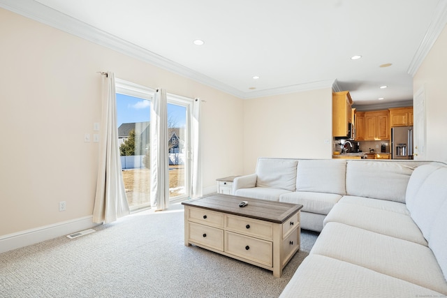 carpeted living room with crown molding and sink