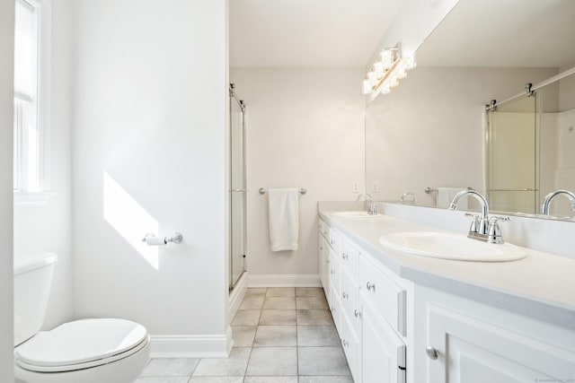 bathroom with tile patterned flooring, vanity, toilet, and a shower with shower door