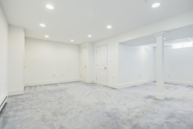 basement with a baseboard heating unit and light colored carpet