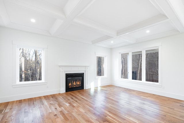 unfurnished living room with coffered ceiling, beam ceiling, and light hardwood / wood-style flooring