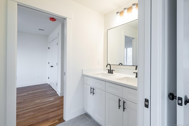 bathroom with vanity and hardwood / wood-style floors