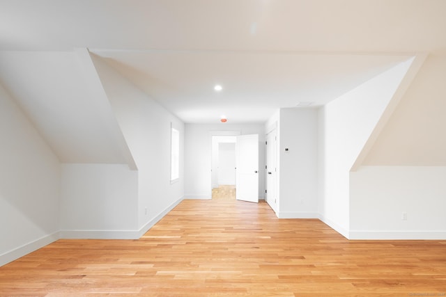 bonus room with lofted ceiling and light hardwood / wood-style floors