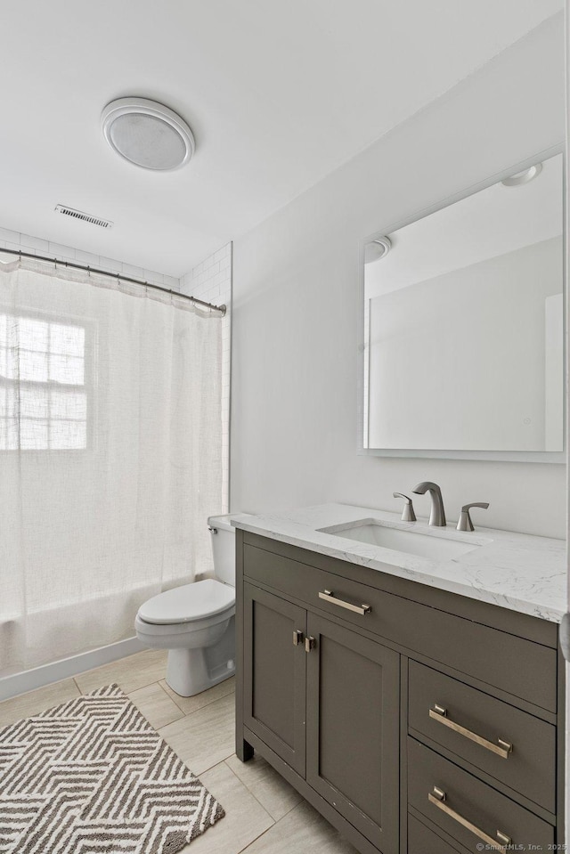 bathroom featuring toilet, shower / tub combo, vanity, and visible vents