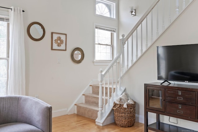 stairway featuring wood finished floors and baseboards