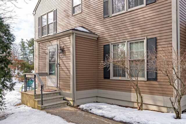 view of snow covered property entrance