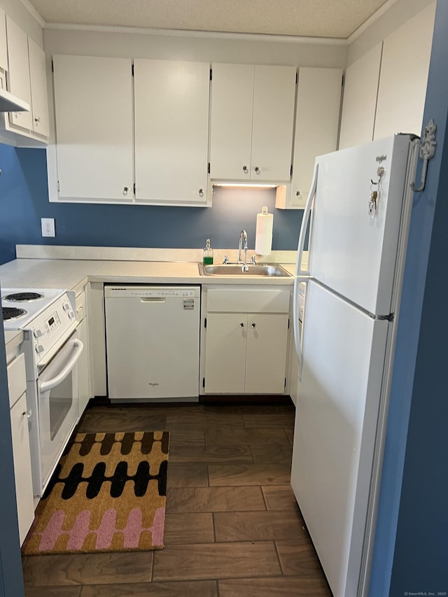 kitchen featuring sink, white appliances, and white cabinets