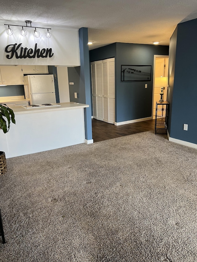 living room with dark carpet and a textured ceiling