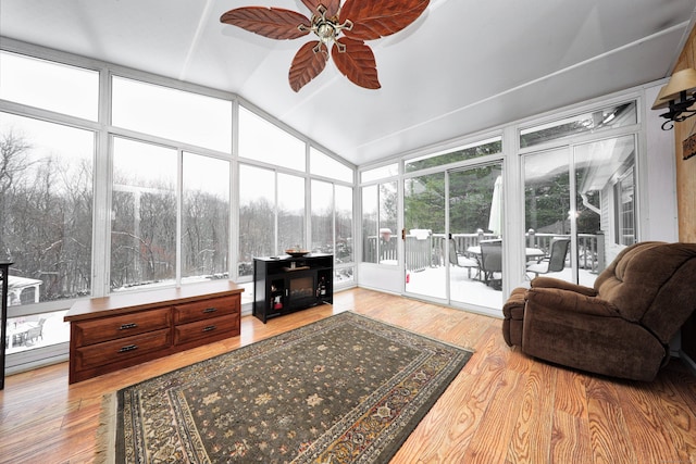 sunroom featuring lofted ceiling and ceiling fan