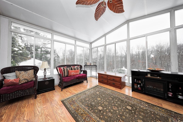 sunroom / solarium with lofted ceiling and ceiling fan