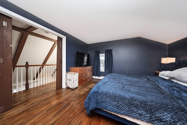 bedroom with vaulted ceiling, dark wood-type flooring, and baseboard heating