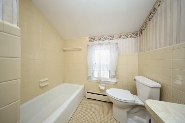 bathroom featuring tile walls, a tub to relax in, tile patterned flooring, a baseboard heating unit, and toilet