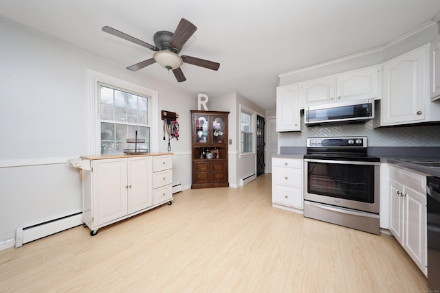 kitchen with white cabinetry, appliances with stainless steel finishes, and a baseboard radiator