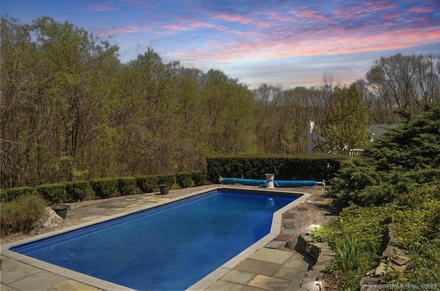 view of pool at dusk