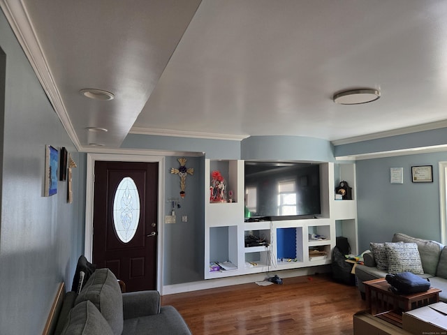 living room with wood-type flooring and ornamental molding