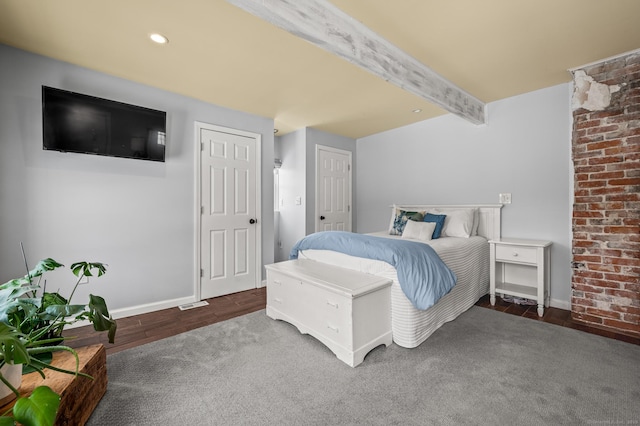 bedroom featuring dark hardwood / wood-style flooring and beam ceiling