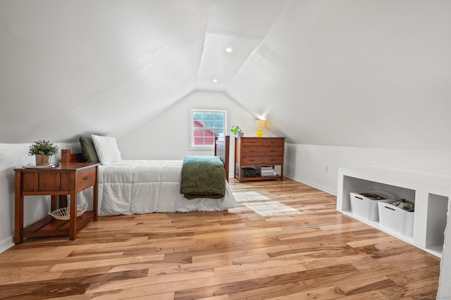 bedroom with vaulted ceiling and light hardwood / wood-style floors