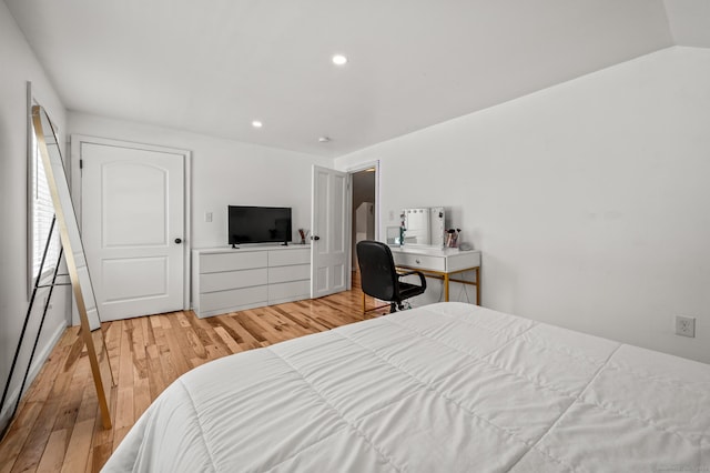 bedroom featuring hardwood / wood-style flooring and vaulted ceiling