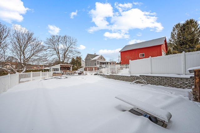 yard layered in snow featuring an outdoor structure