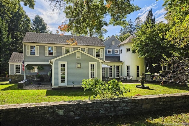 back of house with a yard and a patio area