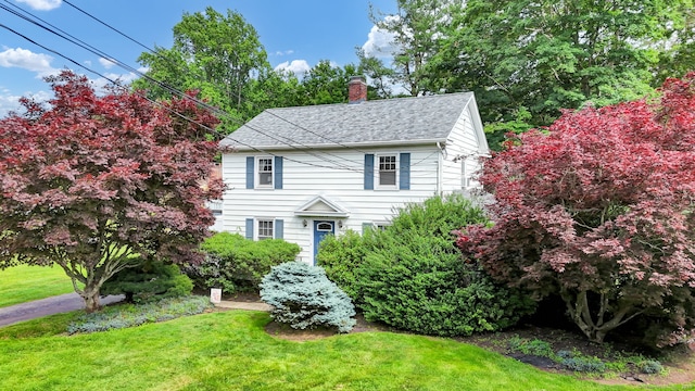 1379 Old N Colony Rd, Meriden, CT 06450 - view of front of house featuring a chimney, a front lawn, and a shingled roof