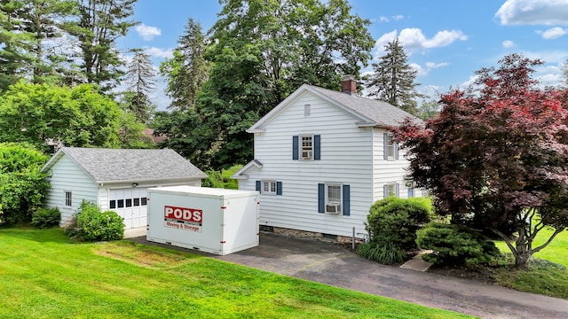 1379 Old N Colony Rd, Meriden, CT 06450 - back of house with a lawn, a detached garage, a chimney, an outdoor structure, and cooling unit