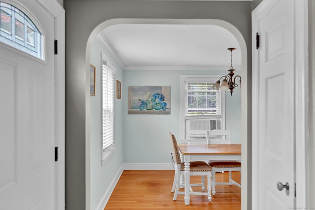 1379 Old N Colony Rd, Meriden, CT 06450 - dining space with arched walkways, a chandelier, light wood-type flooring, crown molding, and cooling unit