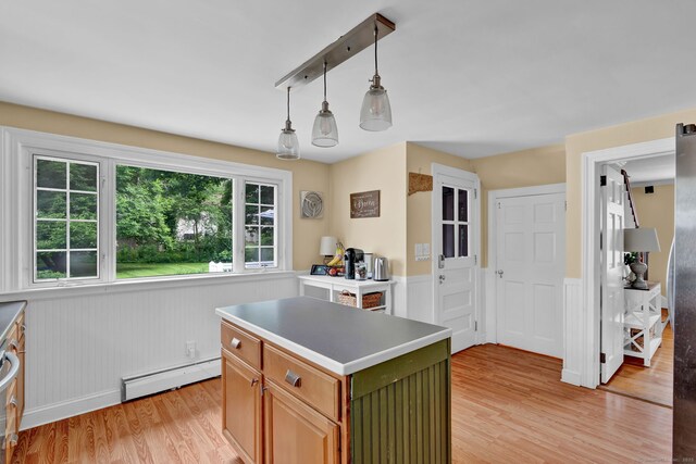 1379 Old N Colony Rd, Meriden, CT 06450 - kitchen with baseboard heating, light wood-type flooring, wainscoting, a center island, and pendant lighting