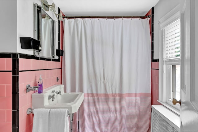 1379 Old N Colony Rd, Meriden, CT 06450 - bathroom featuring tile walls, radiator, a shower with curtain, and wainscoting