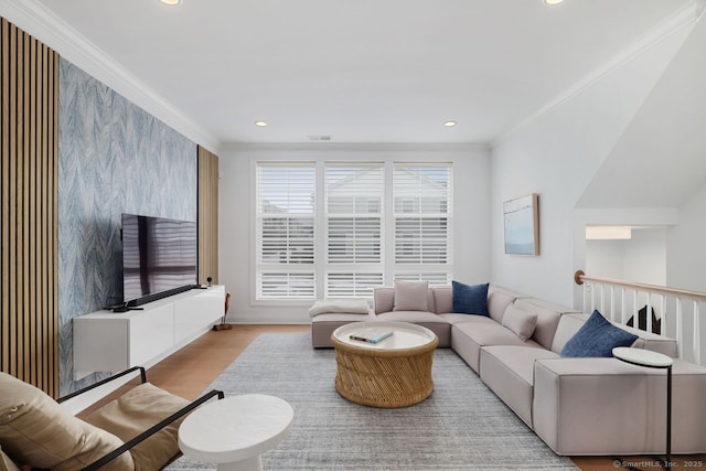 living room featuring crown molding and light hardwood / wood-style flooring