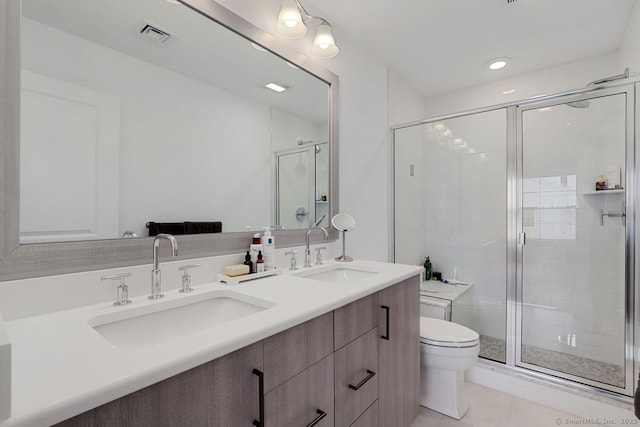 bathroom with tile patterned flooring, vanity, walk in shower, and toilet