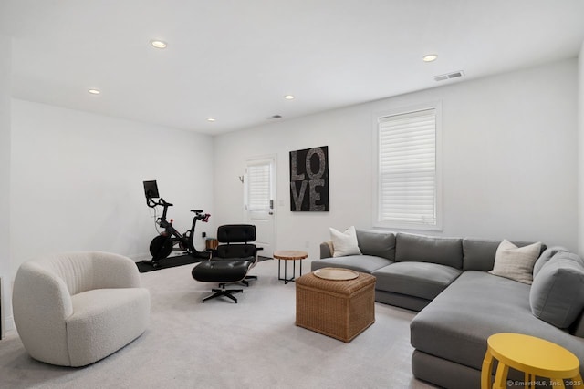 living room featuring plenty of natural light and light colored carpet