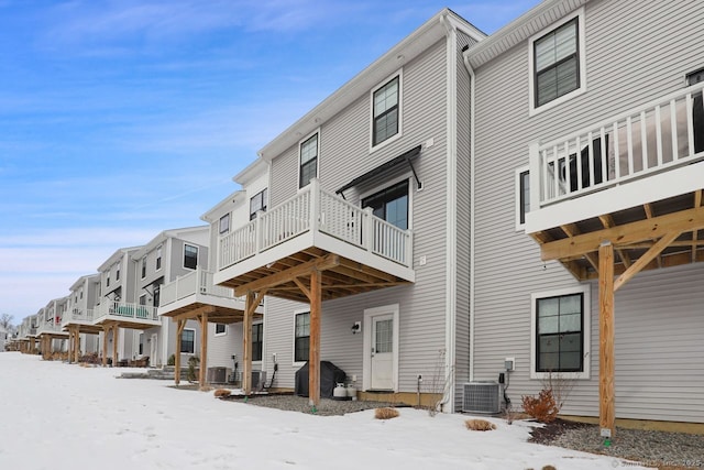 snow covered property featuring central air condition unit