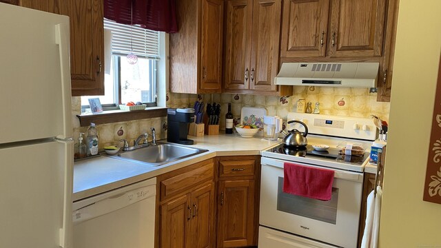 kitchen featuring tasteful backsplash, sink, white appliances, and ventilation hood