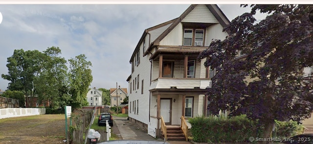 view of front of home featuring fence