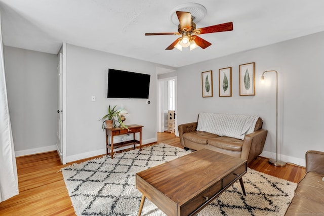 living room with ceiling fan and light wood-type flooring