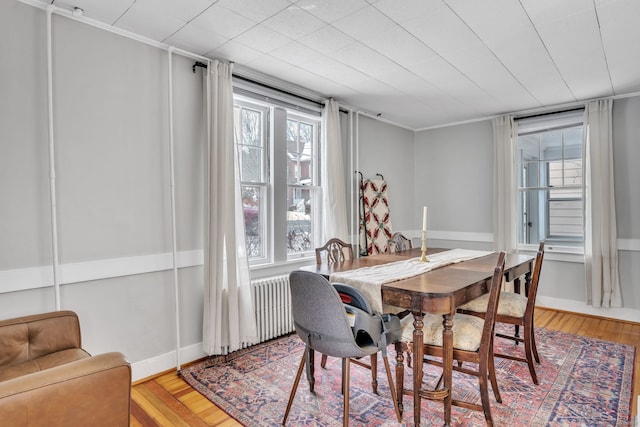 dining space with hardwood / wood-style floors