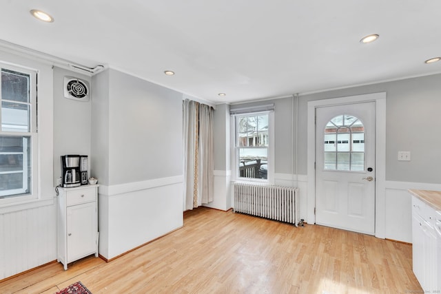 entryway featuring light hardwood / wood-style flooring and radiator heating unit