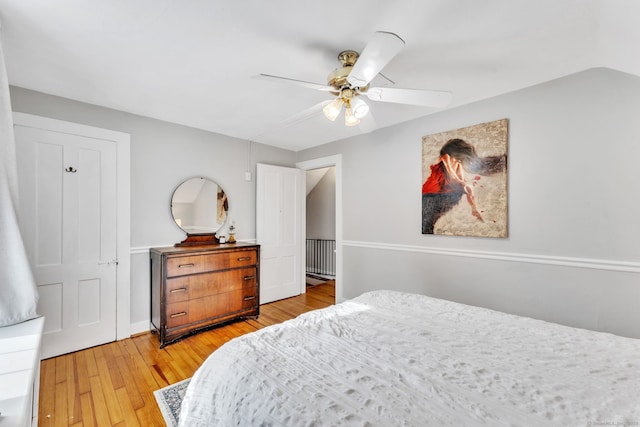 bedroom with light hardwood / wood-style floors and ceiling fan