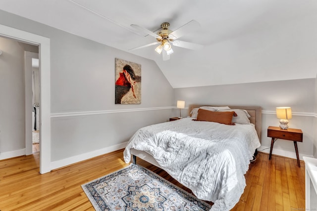 bedroom with lofted ceiling, wood-type flooring, and ceiling fan