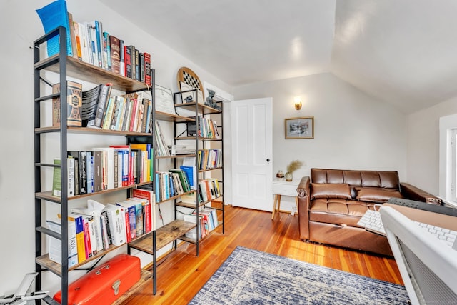 living area with lofted ceiling and light wood-type flooring