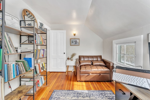 sitting room with lofted ceiling and light hardwood / wood-style flooring