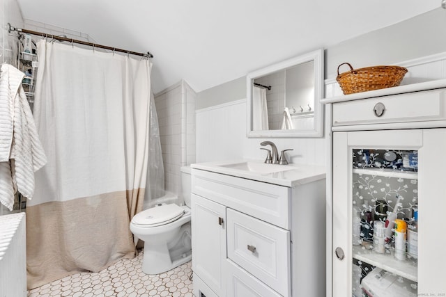 full bathroom featuring vanity, shower / bath combination with curtain, and toilet