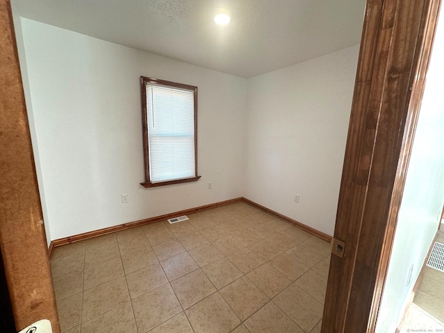 empty room with light tile patterned floors