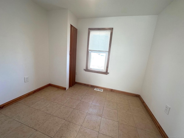 spare room featuring light tile patterned floors