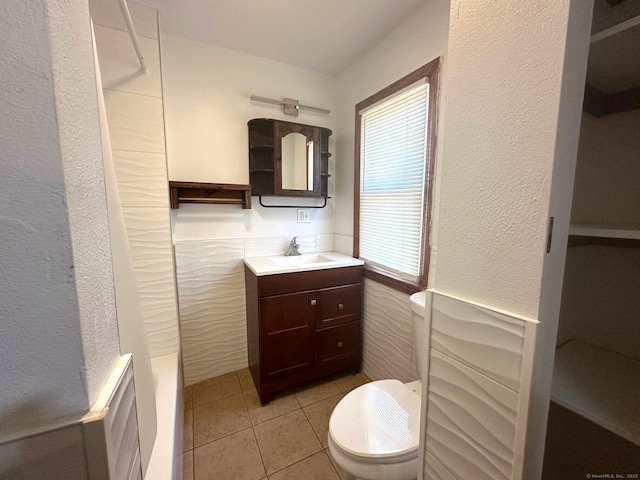 bathroom featuring vanity, tile patterned floors, and toilet