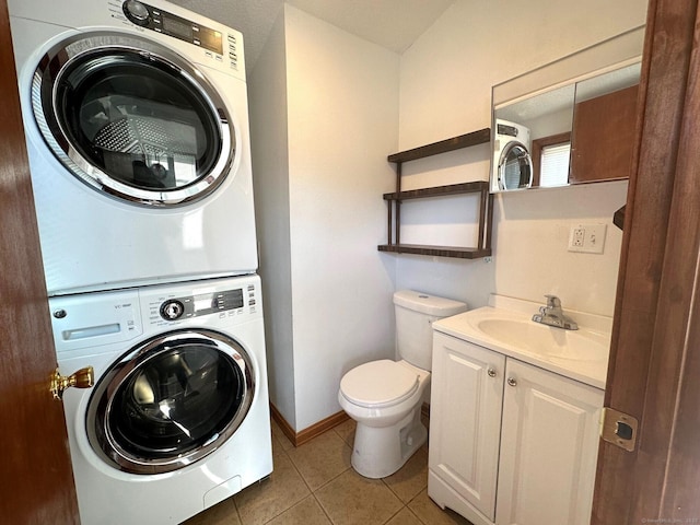 washroom featuring stacked washer and dryer, tile patterned flooring, and sink