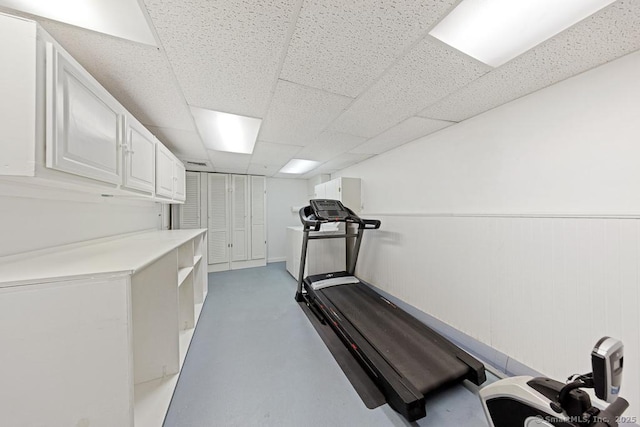 exercise area featuring a paneled ceiling