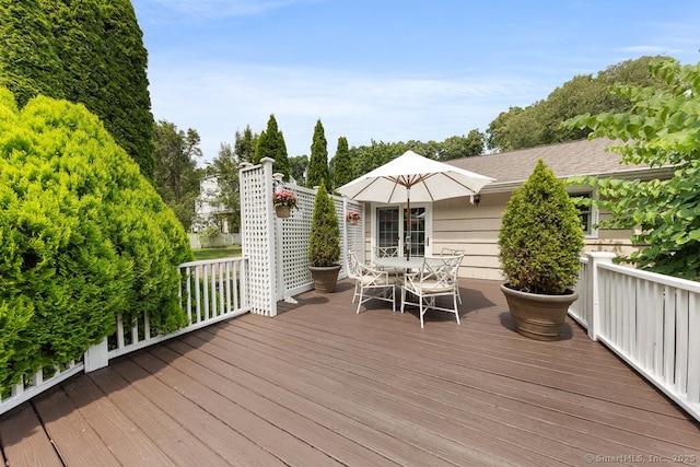 wooden deck featuring outdoor dining space