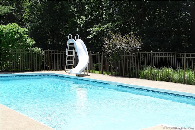 view of swimming pool with a water slide