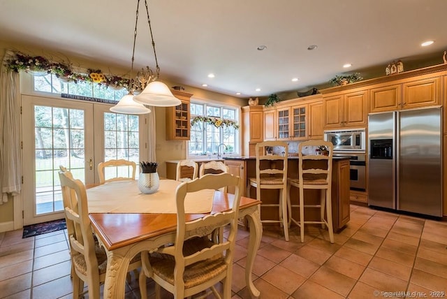 dining area featuring french doors and light tile patterned floors